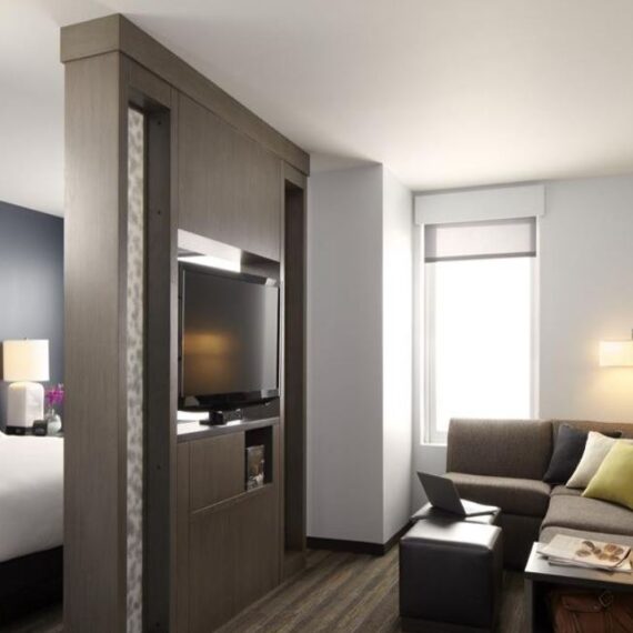 Hyatt House hotel guest room window with roller shades